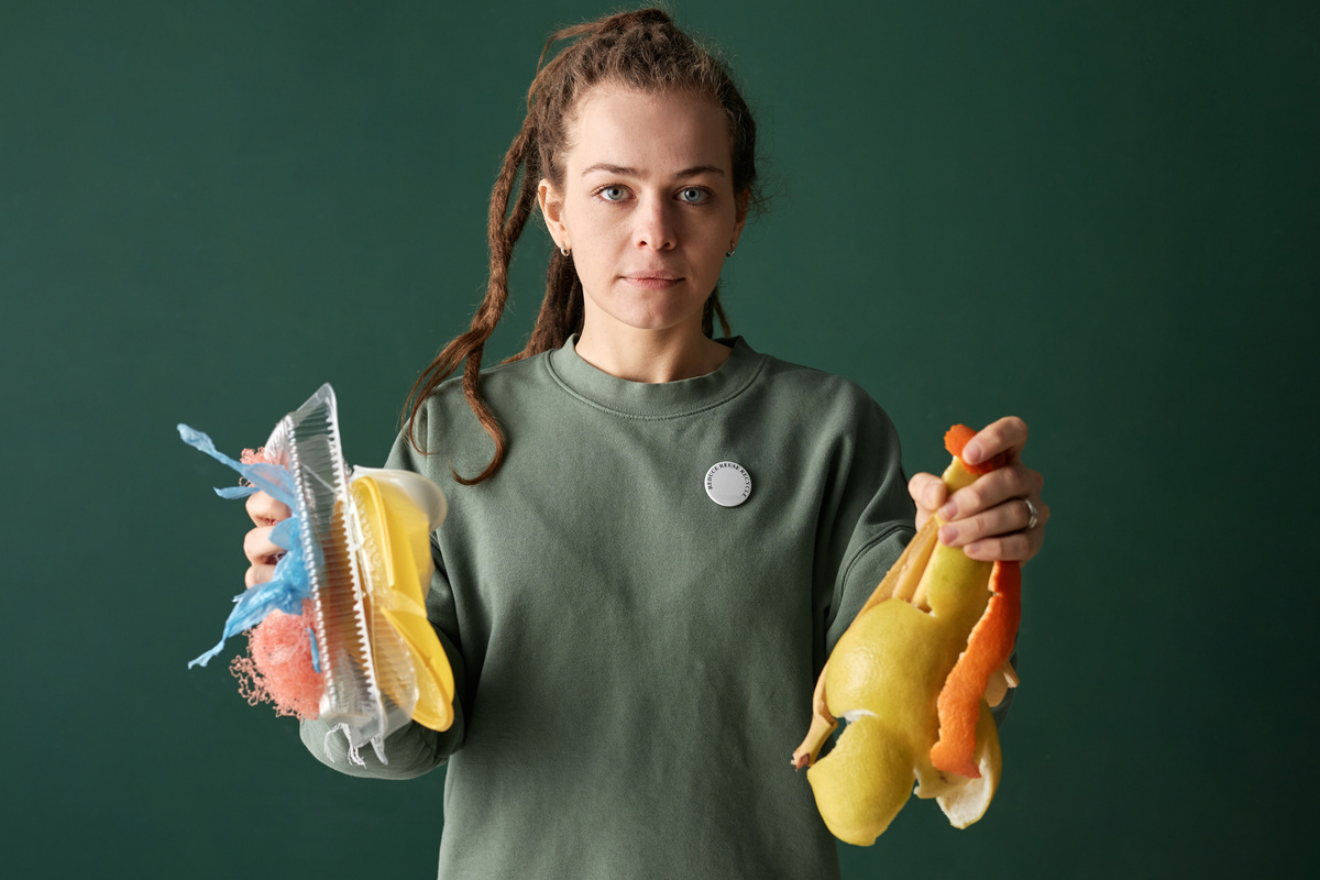 Woman Holding Plastic and Organic Trash in Hands