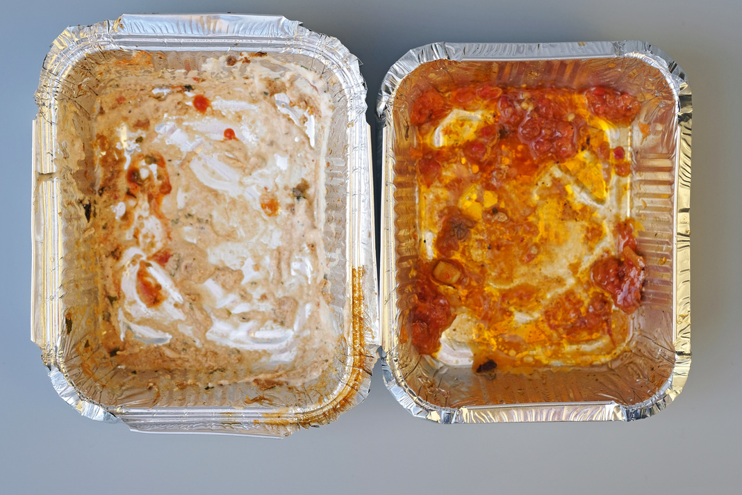 Two dirty empty aluminum containers top view. Food containers