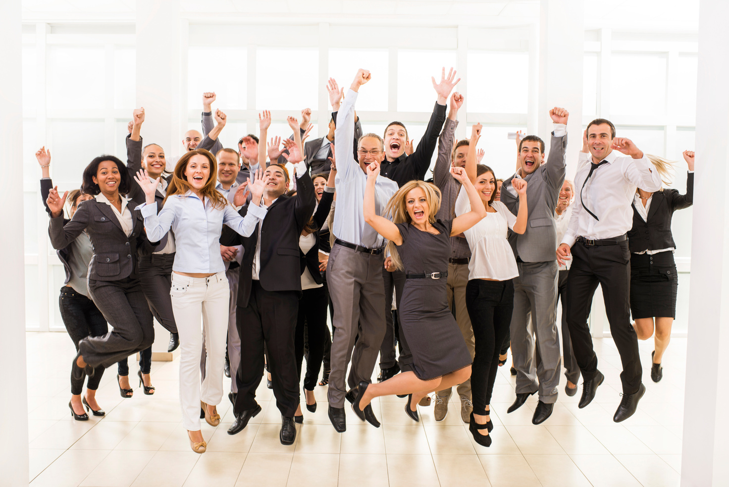 Large group of cheerful business people jumping.